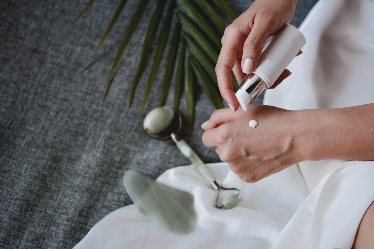 Woman using a jade roller for facial massage as part of an anti-aging skincare routine